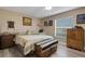 Comfortable bedroom featuring a ceiling fan, neutral walls, wood-look flooring, and a large window at 3147 Sydney Dover Rd, Dover, FL 33527
