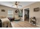 Cozy bedroom with wood floors, a ceiling fan, and natural light streaming through the windows at 3147 Sydney Dover Rd, Dover, FL 33527