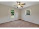 Bedroom featuring a window view, ceiling fan, and neutral carpet flooring at 3147 Sydney Dover Rd, Dover, FL 33527