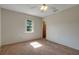 Bright bedroom with a ceiling fan, window, and neutral-colored carpet flooring at 3147 Sydney Dover Rd, Dover, FL 33527