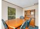 Classic dining room with wooden table, chairs, hutch, window, and trim for a warm gathering space at 3147 Sydney Dover Rd, Dover, FL 33527
