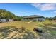 Exterior view of the home, showcasing the expansive yard and outbuildings at 3147 Sydney Dover Rd, Dover, FL 33527