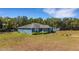 Exterior view of the charming home with lush landscaping and mature trees at 3147 Sydney Dover Rd, Dover, FL 33527