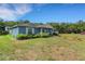 Single story home with an expansive lawn and exterior landscaping at 3147 Sydney Dover Rd, Dover, FL 33527