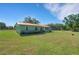 A lawn view of the exterior of the home at 3147 Sydney Dover Rd, Dover, FL 33527