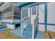 Inviting front entrance with blue painted steps and railings leading to a white door with the house number visible at 3147 Sydney Dover Rd, Dover, FL 33527