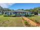 Charming single-story home with a well-maintained lawn, flower beds, and inviting walkway at 3147 Sydney Dover Rd, Dover, FL 33527