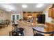 Bright kitchen with granite countertops, wooden cabinets, and a breakfast bar with seating for a modern design at 3147 Sydney Dover Rd, Dover, FL 33527
