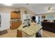 Bright kitchen with granite countertops, wooden cabinets, and a breakfast bar, open to the living area at 3147 Sydney Dover Rd, Dover, FL 33527