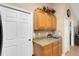 Kitchen area featuring modern cabinets and countertops, with neutral tiled backsplash and flooring at 3147 Sydney Dover Rd, Dover, FL 33527