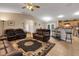 Spacious living room featuring tile flooring, ceiling fan, and an open floorplan to the kitchen with a breakfast bar at 3147 Sydney Dover Rd, Dover, FL 33527