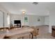View of open-plan living area featuring tile flooring, neutral paint, and breakfast bar seating at 3147 Sydney Dover Rd, Dover, FL 33527
