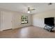 Living room featuring a door, window, ceiling fan, and neutral-colored tiled flooring at 3147 Sydney Dover Rd, Dover, FL 33527