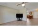Living room featuring a TV and neutral-colored tiled flooring at 3147 Sydney Dover Rd, Dover, FL 33527