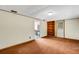 Living room featuring brown carpet, a built-in bookshelf, and natural light, ready for relaxation and entertaining at 3147 Sydney Dover Rd, Dover, FL 33527