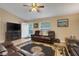 Comfortable living room with a ceiling fan, natural light, and comfortable leather couches at 3147 Sydney Dover Rd, Dover, FL 33527