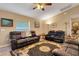 Comfortable living room with a ceiling fan, natural light, and comfortable leather couches at 3147 Sydney Dover Rd, Dover, FL 33527