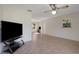 Spacious living room featuring tile flooring, a ceiling fan, and natural light from the window at 3147 Sydney Dover Rd, Dover, FL 33527