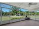 The screened-in patio features a ceiling fan and offers a tranquil view of the outdoors at 3147 Sydney Dover Rd, Dover, FL 33527