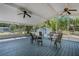 Covered patio with blue painted flooring, ceiling fans, and outdoor seating at 3147 Sydney Dover Rd, Dover, FL 33527