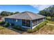 View of the back of the home featuring a screened-in porch, siding, and lush landscaping at 3147 Sydney Dover Rd, Dover, FL 33527