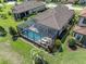 Aerial shot of home with pool, screened enclosure, and well landscaped yard at 3167 Forsythia Dr, Odessa, FL 33556