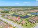Aerial view showcases homes with a pin drop, nestled within a community with lakes and lush green landscaping at 3167 Forsythia Dr, Odessa, FL 33556