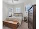 Bedroom featuring a ceiling fan, wooden chest, plantation shutters, and a decorative pillow at 3167 Forsythia Dr, Odessa, FL 33556