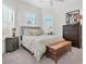 Cozy bedroom with decorative pillows, ceiling fan, wooden chest, and plantation shutters at 3167 Forsythia Dr, Odessa, FL 33556