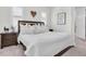Bedroom features a large bed with white bedding, dark furniture, and a framed quote on the wall at 3167 Forsythia Dr, Odessa, FL 33556
