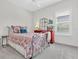 Bedroom with metal bed frame, red dresser, ceiling fan, and plantation shutters at 3167 Forsythia Dr, Odessa, FL 33556