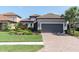 Charming home with well-manicured lawn, paver driveway, and neutral paint scheme at 3167 Forsythia Dr, Odessa, FL 33556