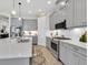 Kitchen features gray cabinets, stainless appliances, quartz countertops, and tile backsplash at 3167 Forsythia Dr, Odessa, FL 33556