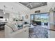 Living room with gray cabinets, stainless appliances, and view of back patio and pool at 3167 Forsythia Dr, Odessa, FL 33556