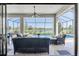Enclosed patio with furniture and a view of the pool and lake at 3167 Forsythia Dr, Odessa, FL 33556