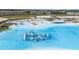 Stunning aerial view of a community lagoon with inflatable structures and sandy beaches at 31890 Griffin Sands Ln, San Antonio, FL 33576
