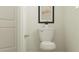 Efficient powder room with a toilet, silver hardware, neutral decor, and a clean aesthetic at 31890 Griffin Sands Ln, San Antonio, FL 33576