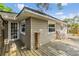 Cozy covered back deck area showing a corner view with furniture and door to the home at 3320 Jackson N St, St Petersburg, FL 33704
