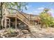 A spacious wooden deck with stairs leads to a charming yard with lush greenery and garden beds at 3320 Jackson N St, St Petersburg, FL 33704