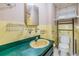 Retro bathroom with a yellow sink, tiled walls, and vintage fixtures at 3320 Jackson N St, St Petersburg, FL 33704