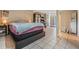 Spacious bedroom with tile floors, natural light, and double doors to the outside at 3320 Jackson N St, St Petersburg, FL 33704