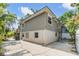 A corner view of the two story home that has an exterior of beige siding and concrete foundation at 3320 Jackson N St, St Petersburg, FL 33704
