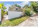 View of the backyard showing the home exterior and a white fence surrounding the property at 3320 Jackson N St, St Petersburg, FL 33704