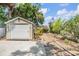 Garage with lush landscaping, a convenient driveway, and a pathway to the main house at 3320 Jackson N St, St Petersburg, FL 33704