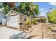 Garage with lush landscaping, a convenient driveway, and a pathway to the main house at 3320 Jackson N St, St Petersburg, FL 33704