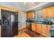 Bright kitchen features wood cabinets, stainless steel appliances, and hardwood floors at 3320 Jackson N St, St Petersburg, FL 33704