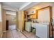 Functional laundry room featuring a washer, dryer, sink, and convenient storage cabinets at 3320 Jackson N St, St Petersburg, FL 33704