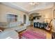 Inviting living room with a sectional sofa, guitar, and view to kitchen at 3320 Jackson N St, St Petersburg, FL 33704