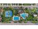 An aerial view of community with multiple pools, tennis courts, and green spaces at 33219 Kateland Dr, Wesley Chapel, FL 33545