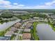 An aerial view shows homes lining streets and lakes in a beautiful residential community at 33219 Kateland Dr, Wesley Chapel, FL 33545